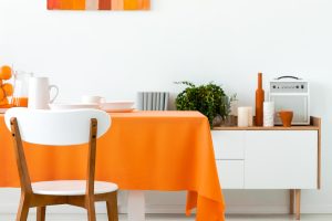 white-wooden-chair-at-table-with-orange-cloth-in-d-2024-10-18-14-31-18-utc.jpg